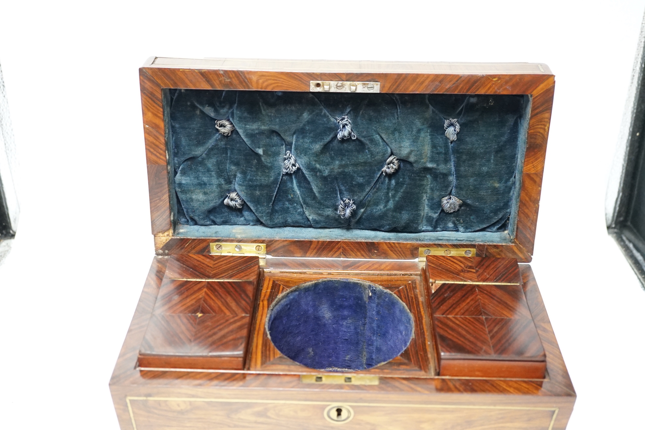 A Regency kingwood and brass strung sarcophagus tea caddy, manufacturers label for Staudenmeyer, 30 Cockspur Street, Charing Cross, London, double headed eagle handles, 21.5cm high, 30.5cm wide, 15cm deep